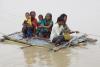 Image of people commuting through a flooded area in North Bihar, India