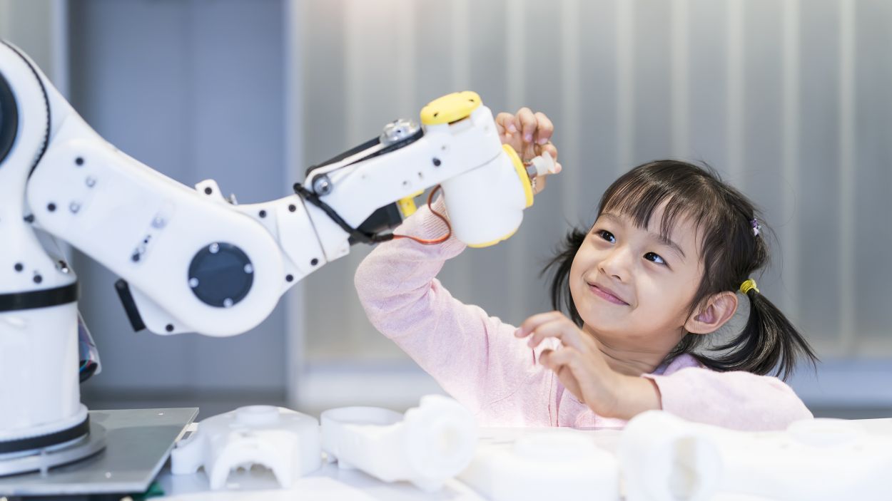         Little girl playing with a robot
      